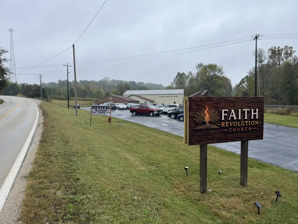 Faith Revolution Church sign and church grounds beside the road