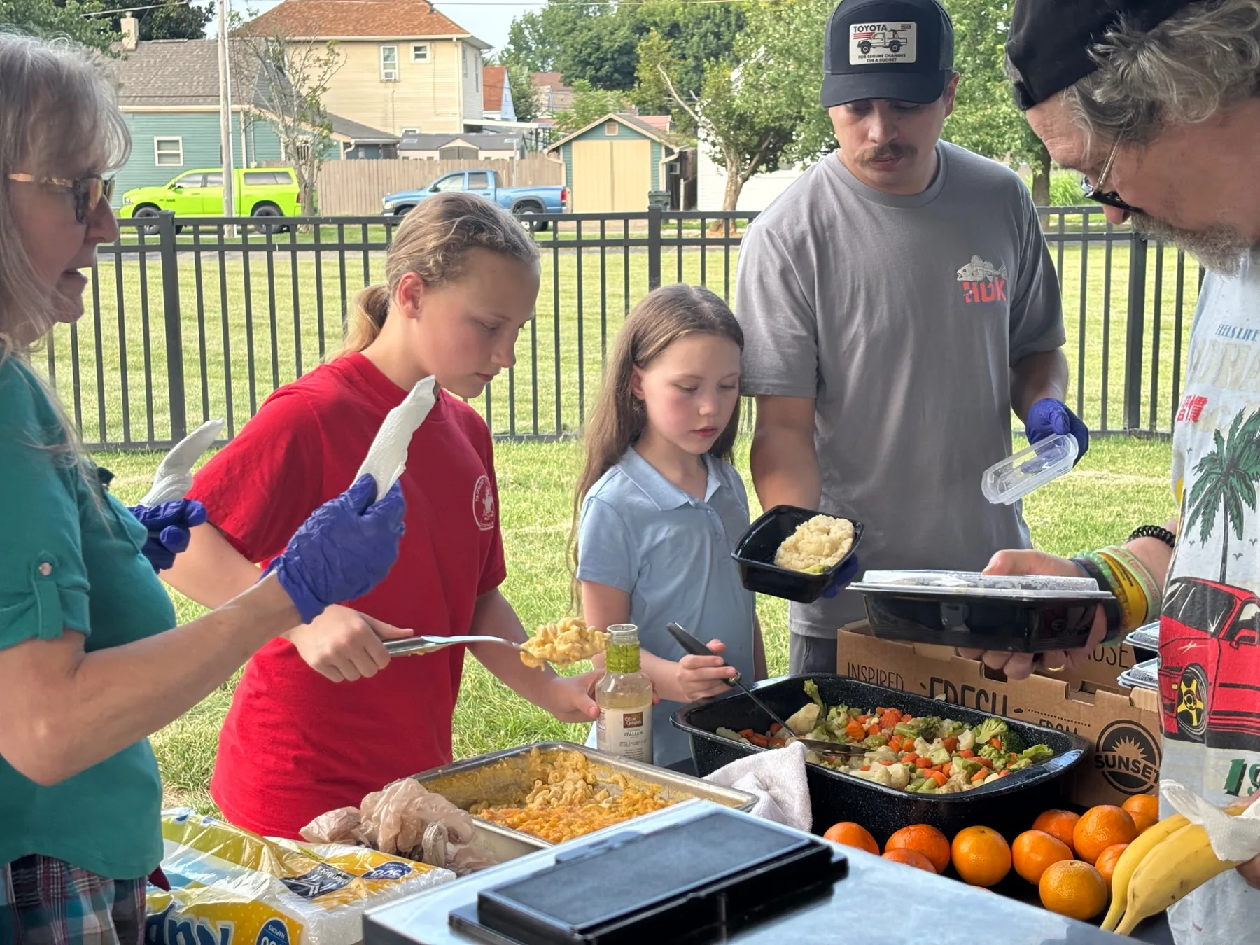 Volunteers portioning meals for homeless outreach at Ritter Park