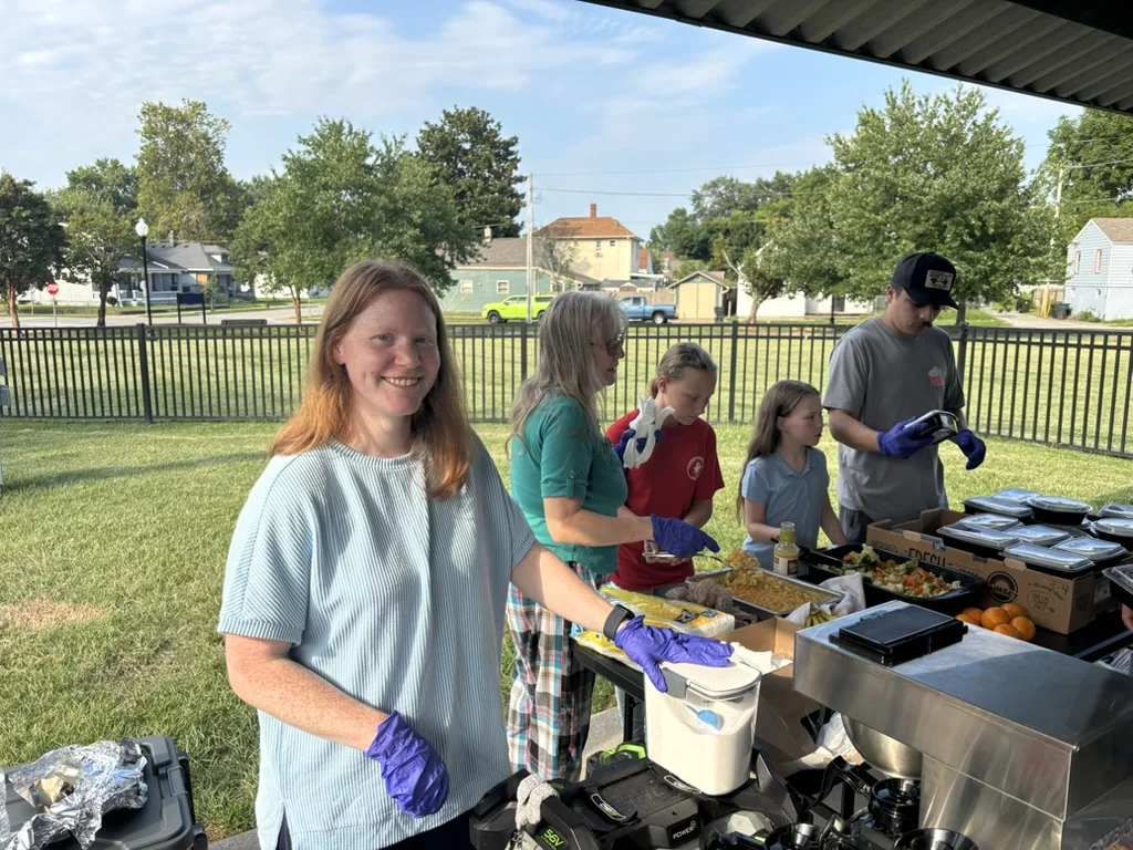 Faith Revolution Church volunteers serving at an outdoor food table